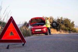 Man with relaxed attitude stranded on the road next to the broke